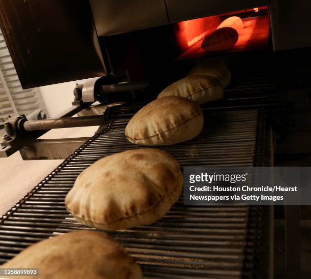 https://media.gettyimages.com/id/1258899893/photo/freshly-baked-pita-bread-rolls-out-of-the-oven-at-phoenicia-specialty-foods-monday-oct-21-in.jpg?s=612x612&w=gi&k=20&c=LTGHmN8y1HMPy0-PqZA_VfxXoiuxqQ3tUIje_SpQZME=