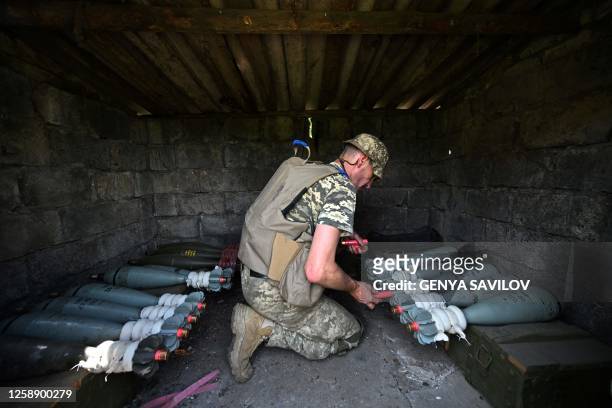 Ukrainian marine of the 35th Brigade prepares 120mm mortar ammunition in the recently liberated village of Storozheve in the Donetsk region, on June...