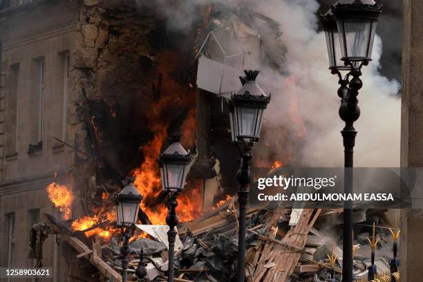 Smoke billows from rubbles of a building at Place Alphonse-Laveran in the 5th arrondissement of Paris, on June 21, 2023. A major fire of unknown...