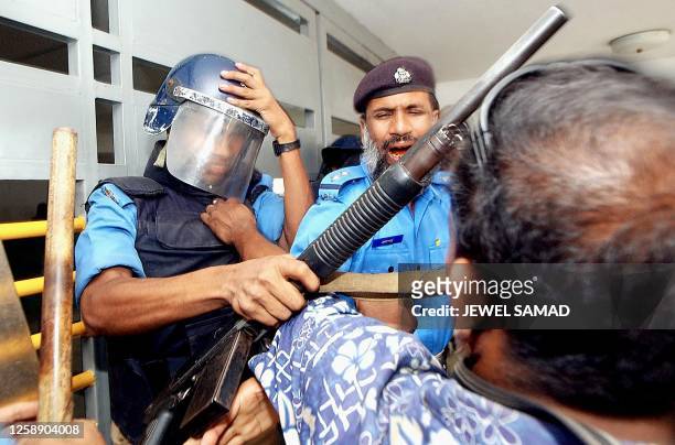Policeman scuffles with a photojournalist while the latter was trying to enter a hospital, where hunger striker-students are being kept, in Dhaka 09...