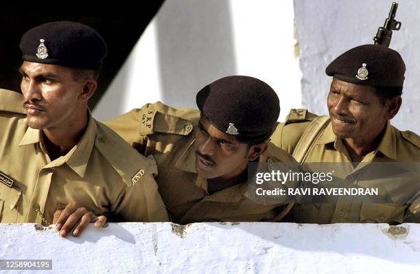 Indian policemen watch the Indian cricket team's practice session at Sardar Patel Gujarat stadium in Ahmedabad, 14 November 2002 on the eve of their...