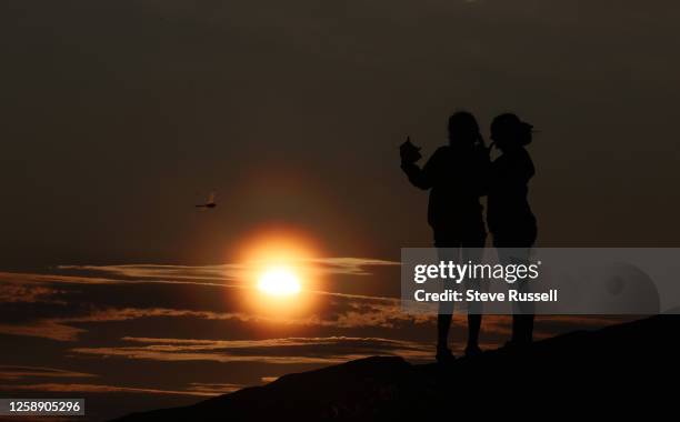 Campers capture sunsets as smoke from wild fires in Northern Ontario and Quebec cause sun halos as the sunsets at Lighthouse Point at Killbear...