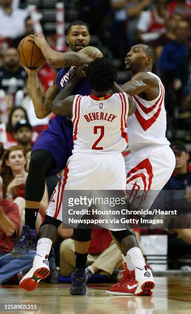 Phoenix Suns forward Marcus Morris is surrounded by Houston Rockets guard Patrick Beverley and Rockets forward Joey Dorsey during the second half of...