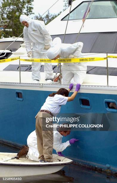 French police and FBI agents from the US examine the catamaran in Phaeton Bay, east of the French Polynesian capital of Papeete, 17 September...