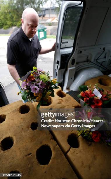Chris Odom loads up his van at Elaine's Florist and Gift Baskets as he prepares to make deliveries, Friday, Feb. 6 in Houston, as orders start coming...