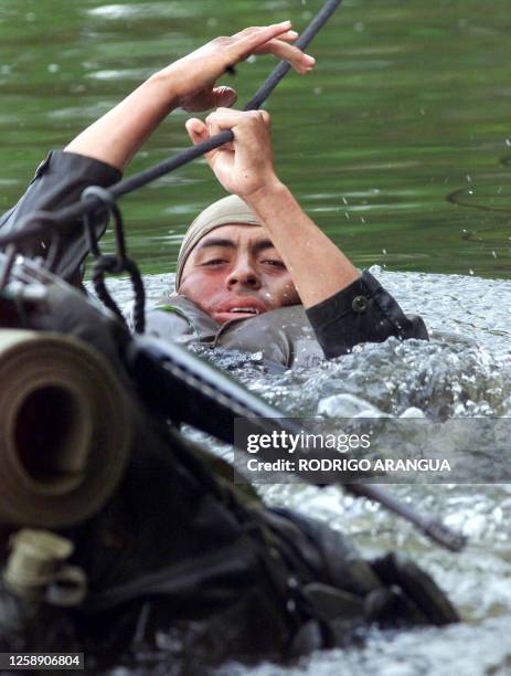 Member of the National Police, being trained by the so called "Jungle Command" for the war against drugs in Colombia is practicing an escape routine,...