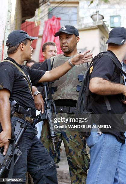 Brazilian police agents search the Rio de Janeiro slum of Aleman 17 September, 2002. Some 200 agents searched through the area looking for alleged...