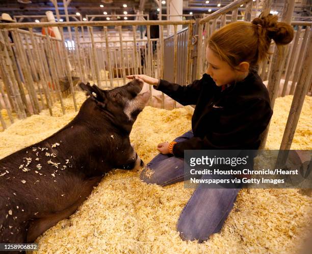 Ashlyn Summers of Midlothian, plays with her pig "Kiley" in her pen in the livestock area in NRG center during the Houston Livestock Show and Rodeo...
