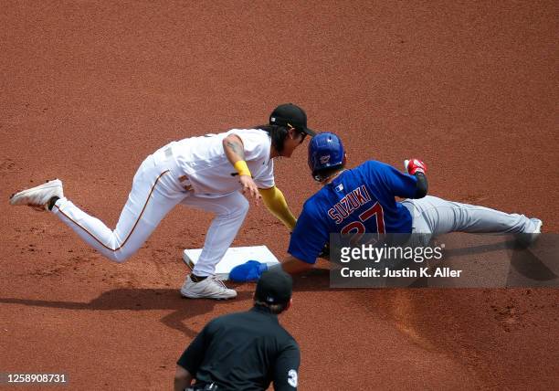 Seiya Suzuki of the Chicago Cubs is caught stealing in the first inning by Ji Hwan Bae of the Pittsburgh Pirates at PNC Park on June 21, 2023 in...