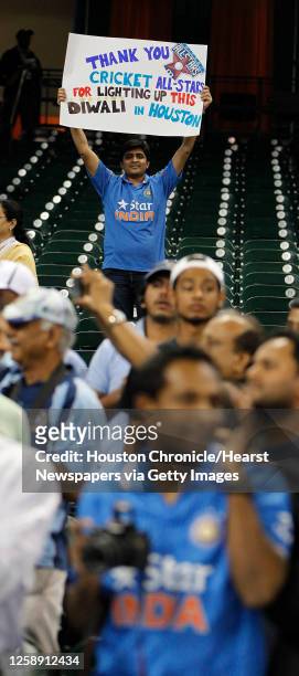 Fan holds a sign reading "Thank you Cricket All-Stars for lighting up this Diwali in Houston" before the start of the Cricket All-Star Series 2015...