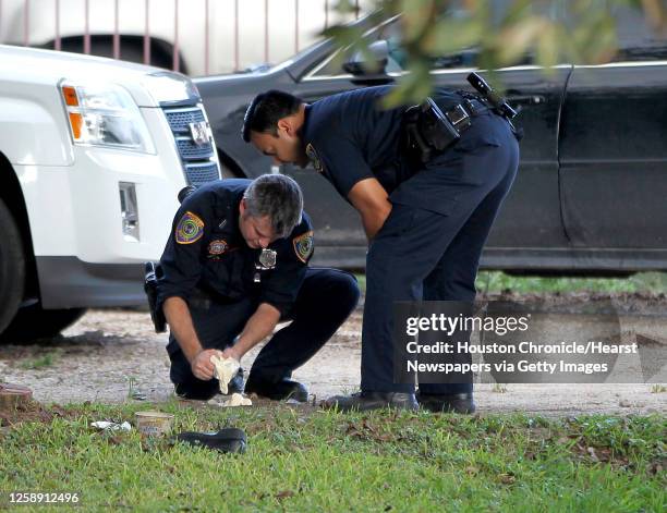 Investigators with the Houston Police department pour a moulding material into a tire track at the scene where a woman in her 20s, was found dead...