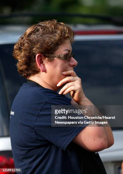 Woman reacts as Houston Police investigate the scene where a woman in her 20s, was found dead with her toddler daughter in their home in the 7800...