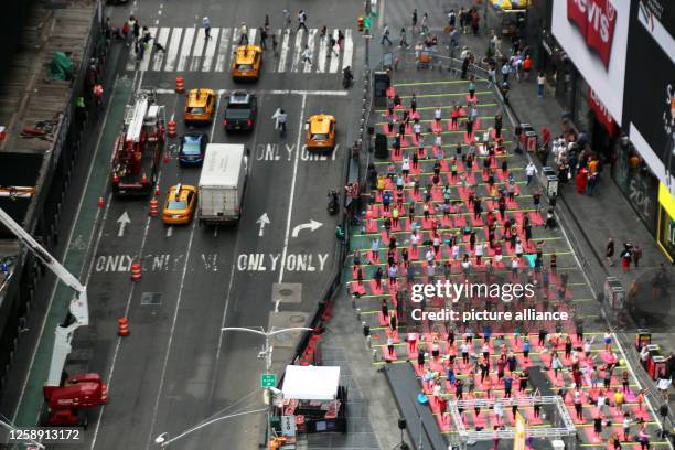 June 2023, USA, New York: Hundreds of people practice mass yoga in Times Square on the occasion of World Yoga Day. The event, offered by the Times...