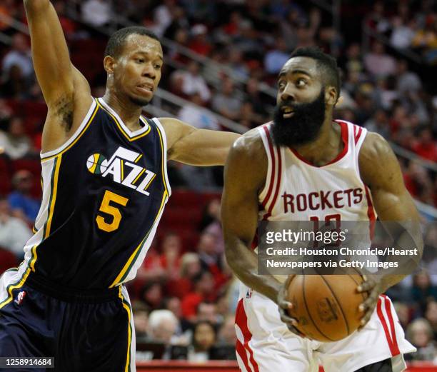 Houston Rockets guard James Harden works against Utah Jazz guard Rodney Hood during the second half of an NBA basketball game at Toyota Center,...