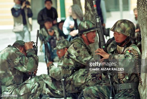 Soldiers maintain a defensive position during a violent demonstration between the military and civilian police protesters 12 February, 2003 in La...