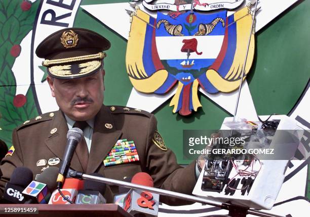 Bogota Police Chief, General Jorge Daniel Castro, shows a remote control panel to the media during a press conference 11 December, 2002 in Bogota....