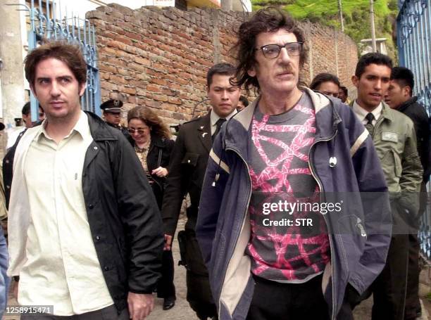 Musician Charly Garcia is escorted by police in Quito, Ecuador 29 December 2002. El músico argentino Charly Garcia , sale acompañado de su...
