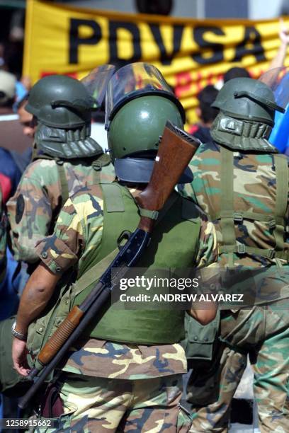 Venezuelan National Guard troops deploy 05 December in Caracas during the fourth day of a nayionwide strike celling for the resignation of President...