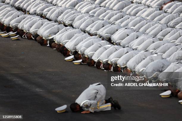 Saudi security forces pray during a military parade as pilgrims arrive for the annual Hajj pilgrimage in the holy city of Mecca on June 21, 2023.