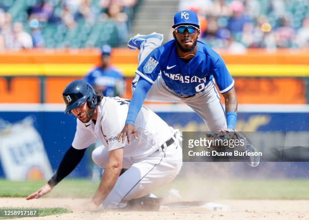 Second baseman Samad Taylor of the Kansas City Royals avoids Jake Marisnick of the Detroit Tigers after turning the ball during the eighth inning at...
