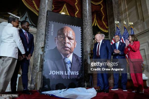 Postmaster General Louis DeJoy , House Minority Leader Hakeem Jeffries and Rep. Nancy Pelosi participate in a stamp unveiling ceremony in honor of...