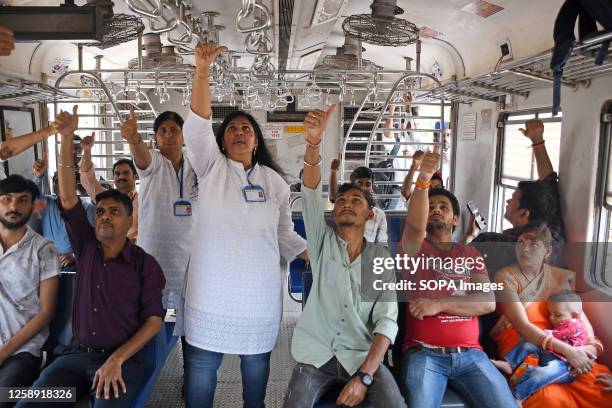 Yoga teachers show commuters a form of yoga exercise inside the local train compartment on the occasion of International Yoga Day. 9th International...