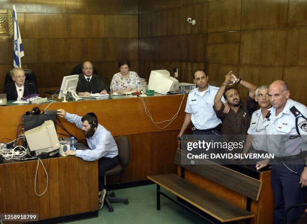 Palestinian West Bank Fatah leader Marwan Barghuti arrives in the Tel Aviv district court 20 May 2004. Barghuti, who was found guilty on several...