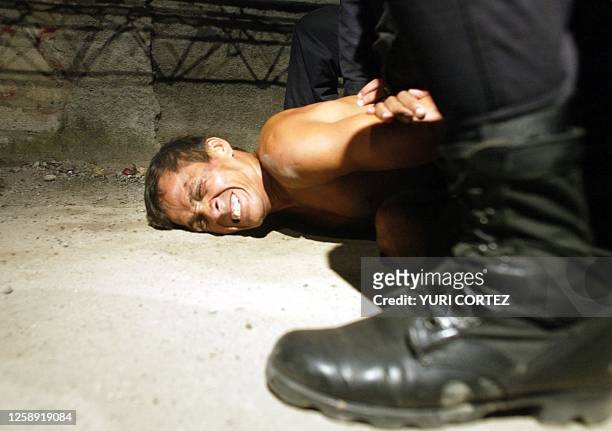 Member of a gang is arrested by police 24 July, 2003 in a poor neighborhood of the outskirts of San Salvador during an operation called "Firm hand"....