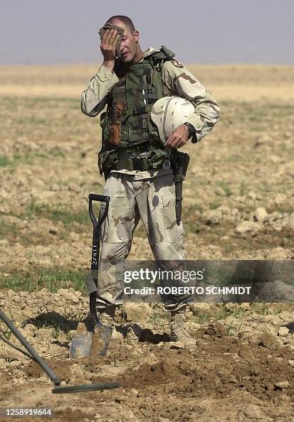 Soldier Rucking Sweating A US soldier from the 720th Military Police Battalion wipes the sweat ...
