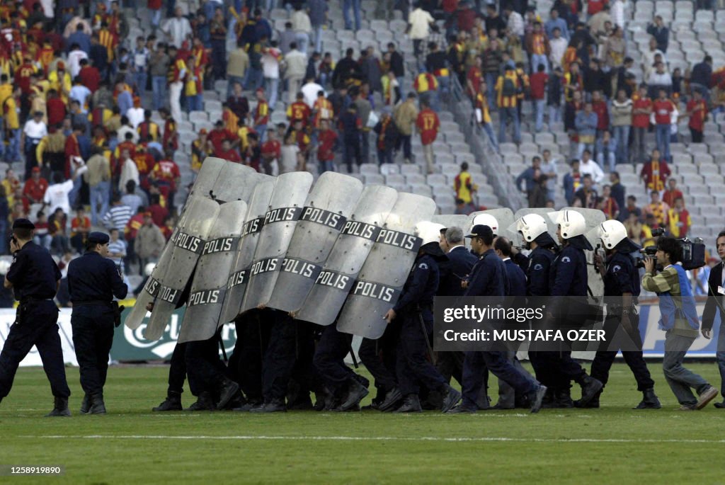 Turkish Football Riots TOPSHOT - Turkish riot policemen raise their sheilds to protect the ...
