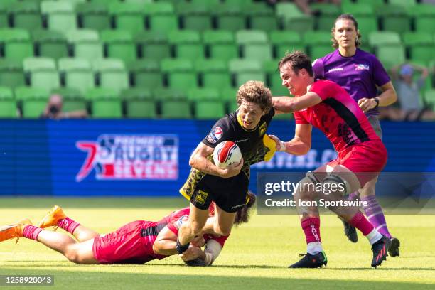 Pittsburgh Steeltoes player Mickey Bateman is tackled by two defenders during the Men's semi-finals match between Pittsburgh Steeltoes and New York...