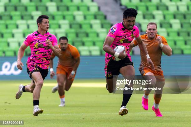 Southern Headliners player Kitiona Vai races toward the end zone while Texas Team player Craig Hunt chases behind during the Men's semi-finals match...