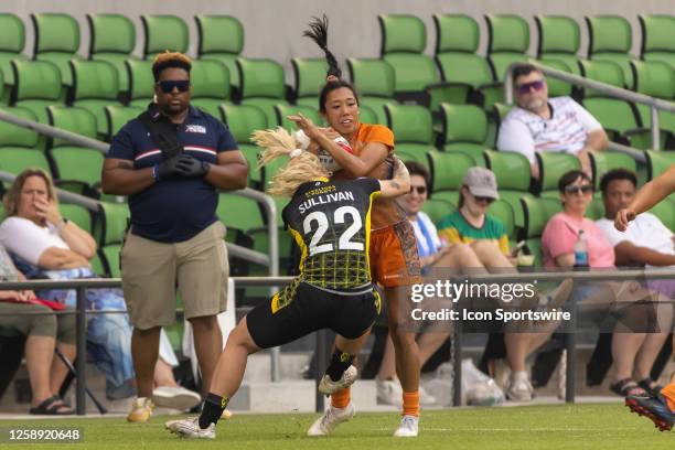 Texas Team player Erica Legaspi is hit hard by Pittsburgh Steeltoes player Sammy Sullivan during the Women's third place match between Texas Team and...