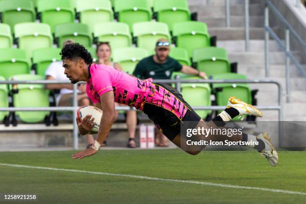 Southern Headliners player Kitiona Vai dives into the end zone for a try during the Mens' third place match between Southern Headliners and...