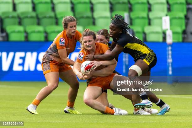 Texas Team player Darian Lovelace is tacked by Pittsburgh Steeltoes player Meg Mambe during the Women's third place match between Texas Team and...