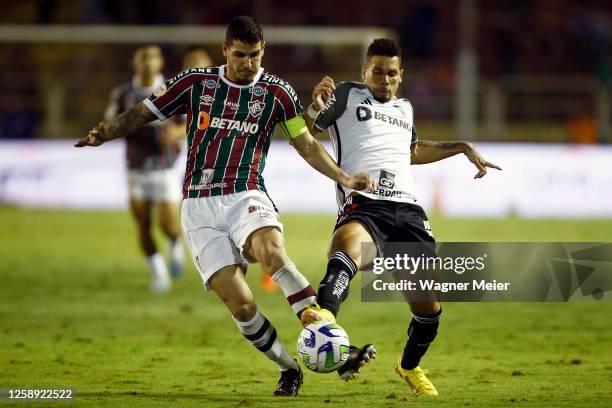 Paulinho of Atletico Mineiro fights for the ball with Nino of Fluminense during the match between Fluminense and Atletico Mineiro as part of...