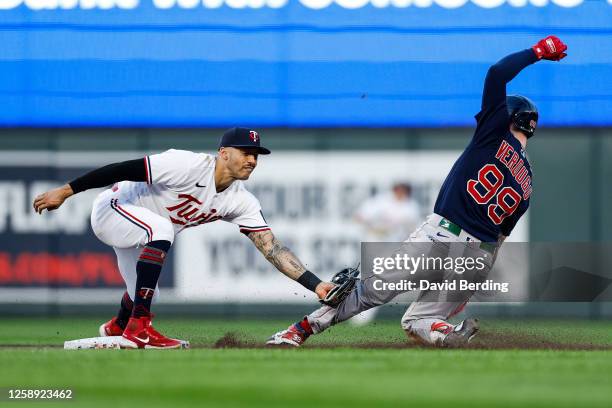 Carlos Correa of the Minnesota Twins tags out Alex Verdugo of the Boston Red Sox at second base trying to stretch his single in the seventh inning at...
