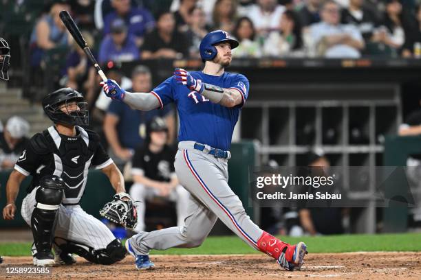 Jonah Heim of the Texas Rangers hits a three-run home run in the fifth inning against the Chicago White Sox at Guaranteed Rate Field on June 21, 2023...