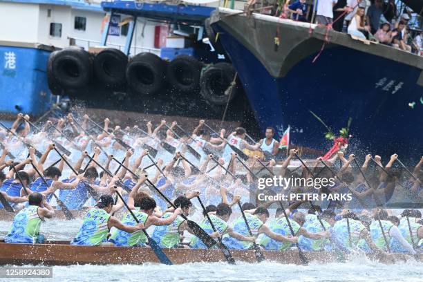 Competitors take part in dragon boat races held to celebrate the Tuen Ng festival in the Aberdeen typhoon shelter in Hong Kong on June 22, 2023.