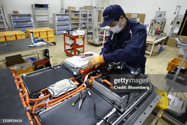 An employee disassembles a used lithium-ion electric vehicle battery at the 4R Energy Corp. Factory in Namie, Fukushima Prefecture, Japan, on...