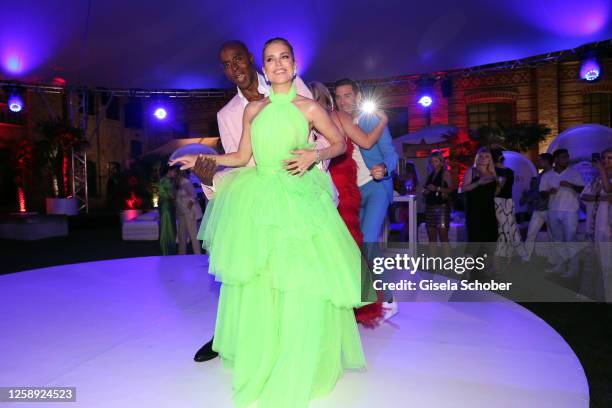 Bruce Darnell and Sylvie Meis dance during the "Raffaello Summer Day" at KPM Hotel & Residences on June 21, 2023 in Berlin, Germany.