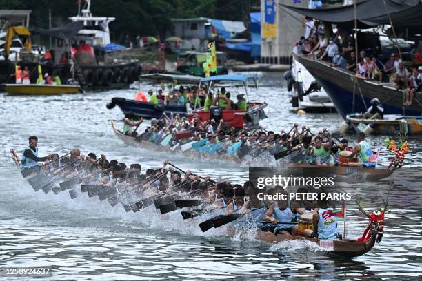 Competitors take part in dragon boat races held to celebrate the Tuen Ng festival in the Aberdeen typhoon shelter in Hong Kong on June 22, 2023.
