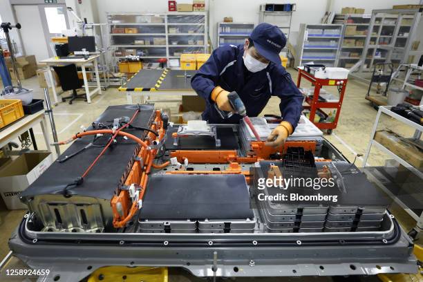 An employee disassembles a used lithium-ion electric vehicle battery at the 4R Energy Corp. Factory in Namie, Fukushima Prefecture, Japan, on...