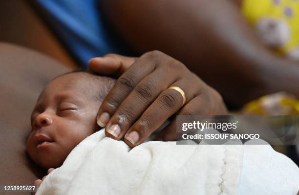 Mother holds her premature baby at the Kangaroo Mothers Unity in the peditric department of the University Hospital Center in Treichville in Abidjan...