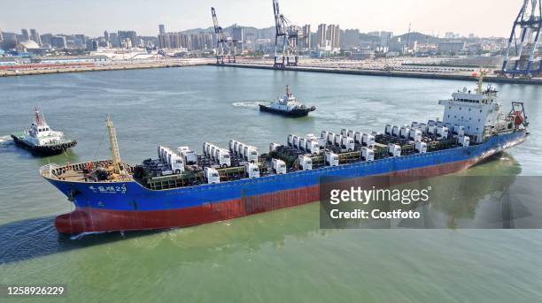 Cargo ship loaded with Chinese-made heavy trucks leaves the port of Yantai, Shandong Province, China, June 21, 2023. 150 Chinese-made heavy trucks...