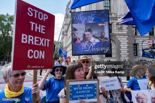 Anti-Brexit protesters continue their campaign against Brexit and the Conservative government in Westminster with a satirical placard which reads...