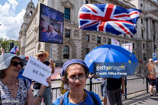 Anti-Brexit protesters continue their campaign against Brexit and the Conservative government in Westminster with a satirical placard which reads...