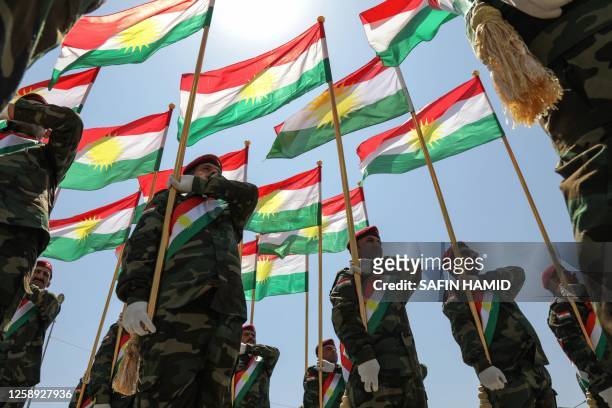 Iraqi-Kurdish Peshmerga officers take part in a graduation ceremony in Arbil, the capital of Iraq's northern autonomous Kurdish region, on June 22,...