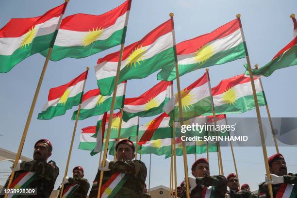 Iraqi-Kurdish Peshmerga officers take part in a graduation ceremony in Arbil, the capital of Iraq's northern autonomous Kurdish region, on June 22,...