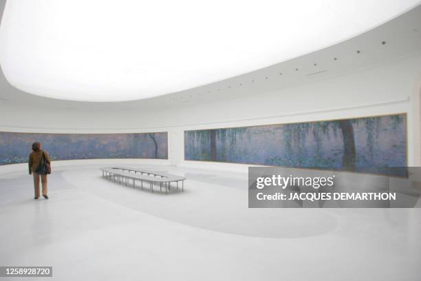 Woman looks at "les Nymphéas" of Claude Monet at the Museum 'L'Orangerie" in Paris, 02 May 2006, which will reopen 17 May 2006 after a six-years...